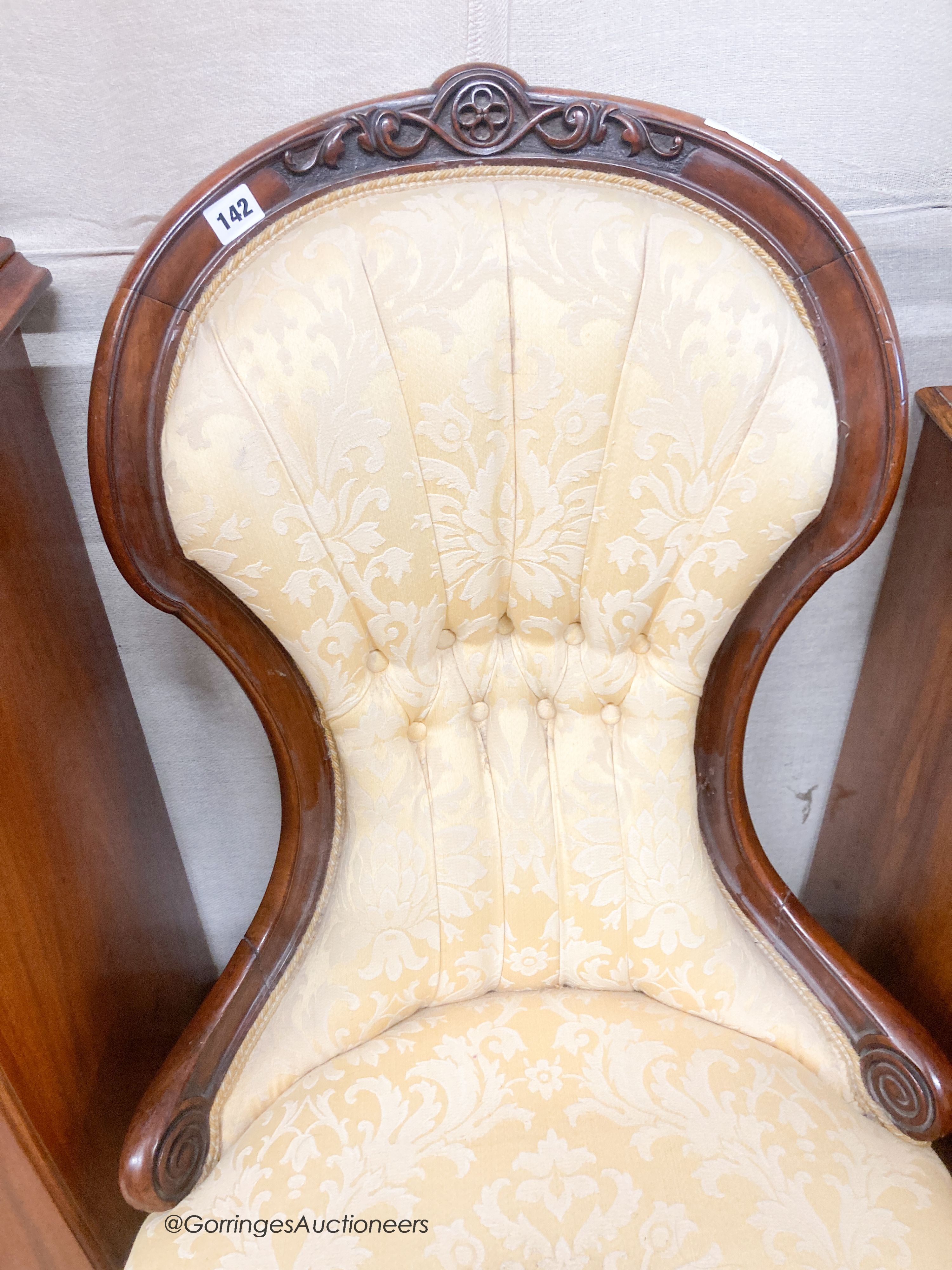 A Victorian walnut spoonback nursing chair